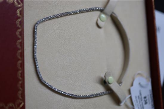 A modern Cartier 18ct white gold and diamond line choker necklace, with Cartier box and certificate dated 14/3/03, 37.5cm.
